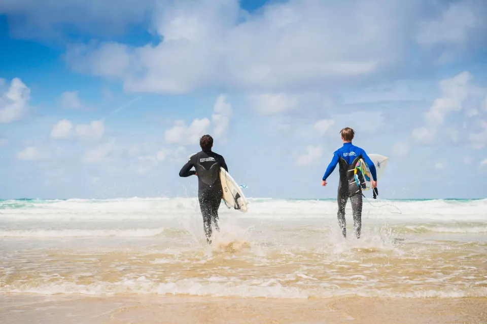 Image collections-surf-stays-1780327124 for Friends running into the sea at Perranporth
