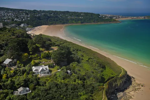 Image locations-west-cornwall-carbis-bay-1777454166 for Parent and child walking along the beach in St Ives