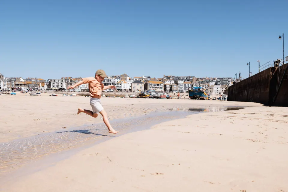 Image may-holidays-cornwall-1788513749 for Boy running on the beach in St Ives