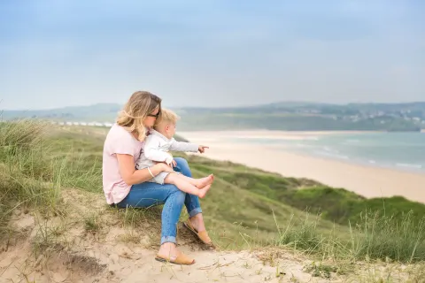 Image september-holidays-cornwall-1783512182 for Mother and child on the beach at Gwithian