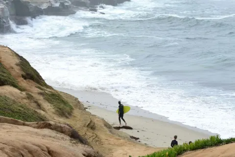Image a-guide-to-loving-the-rain-in-cornwall-1770717118 for Surfers on wet beach
