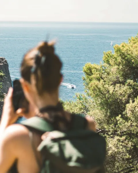 Image cornwalls-most-instagrammable-spots-1781176476 for An image of a woman taking a photograph of the sea on her phone