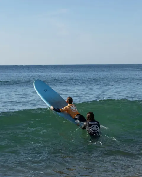 Image the-ultimate-guide-to-coastal-holidays-in-cornwall-1781004727 for An image of a child having a surf lesson