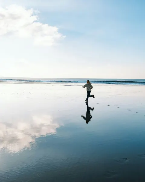 Image why-winter-is-cornwalls-best-kept-secret-1790693150 for Girl running along a Cornish beach in winter